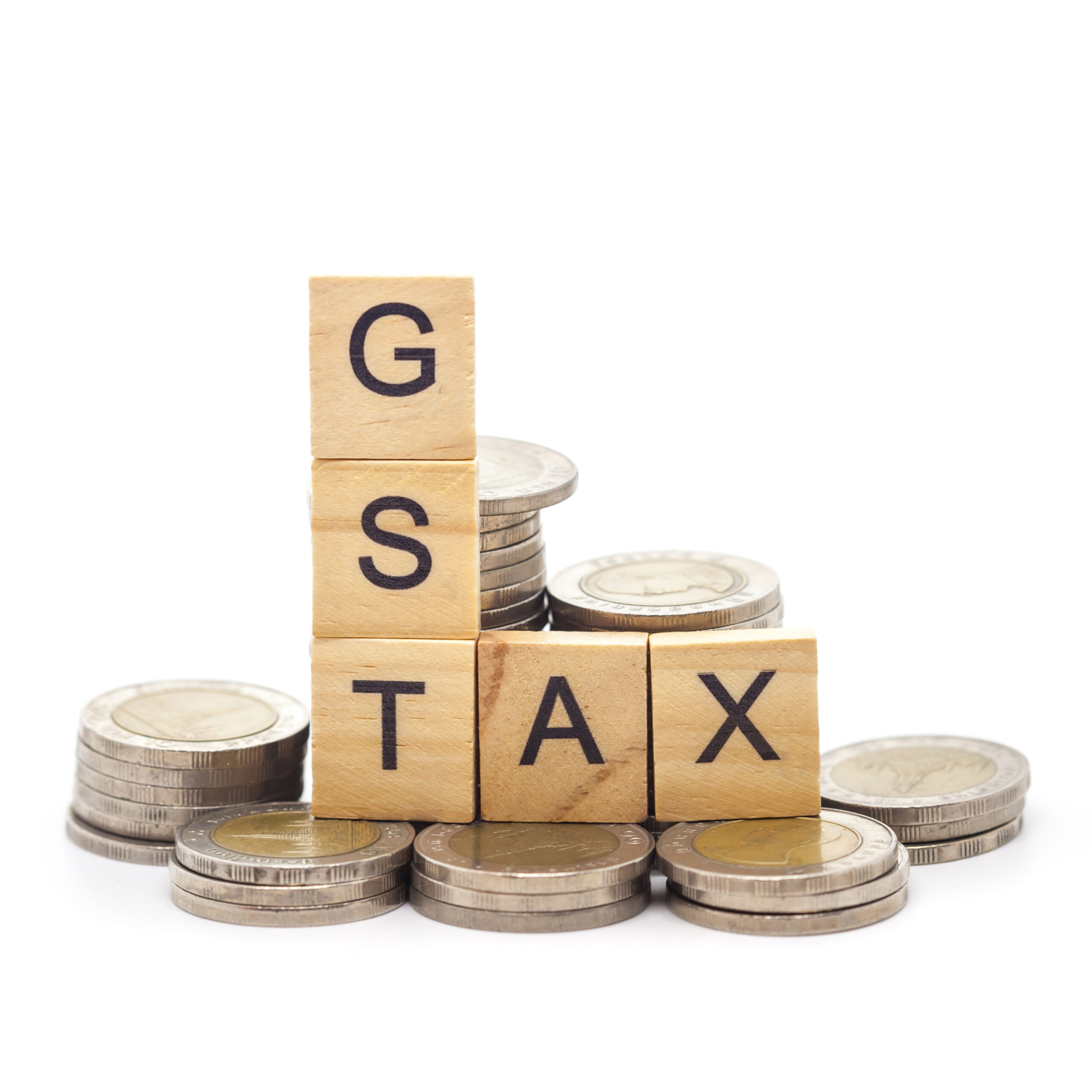 Goods and Services Tax word on stack coins isolate .